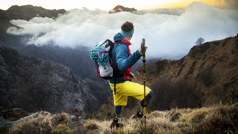 Andrea Lanfri at the top of a mountain with clouds in the valley belowphoto by Ilaria Cariello