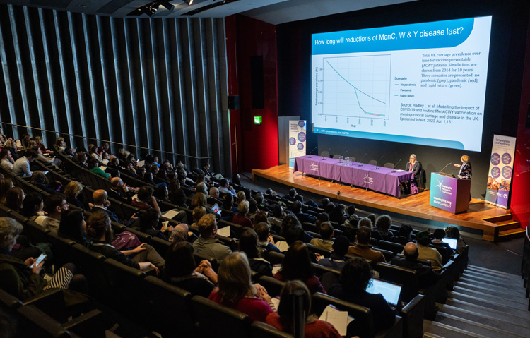 2023 Meningitis Research Conference showing screen and audience