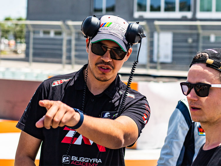 Ludovic Peze talking to a person on the side of the racetrack (car racing)