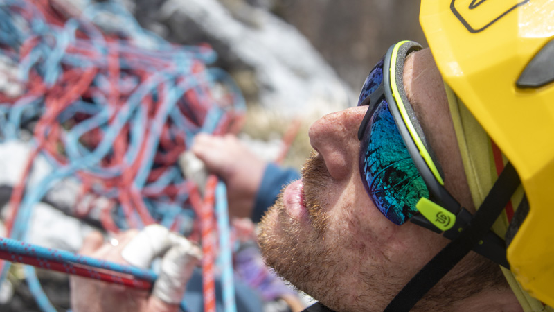 Andrea Lanfri closeup with climbing equipement in the background - Photo by Ilaria Cariello