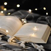 Open book with fairy lights around