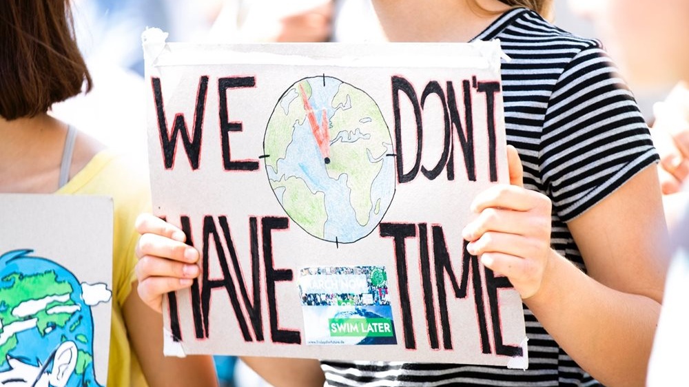 An activist's placard which reads: 'We don't have time'.