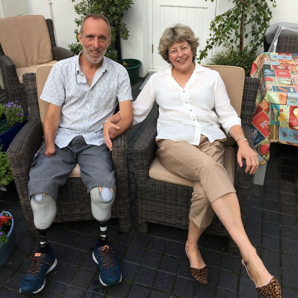 Mike and Julie Davies smiling in their garden