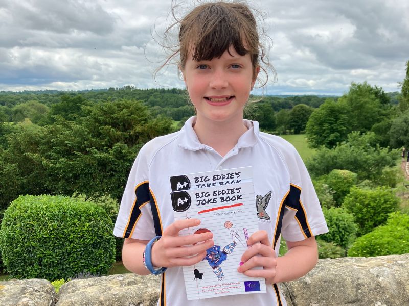 Maddie Davies smiling holding Big Eddie's Joke Book