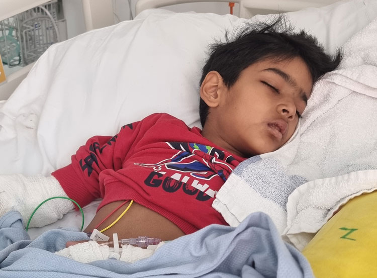 Mahwish Mustafa's son, ali, lying in a hospital bed