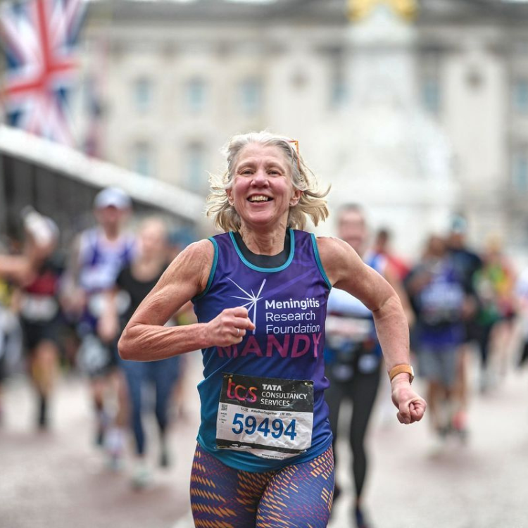 Amanda Warnett running in a charity vest to raise money for the Meningitis Research Foundation.