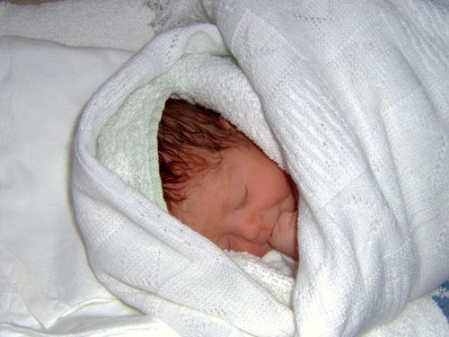 Baby Amber harris wrapped in a white blanket