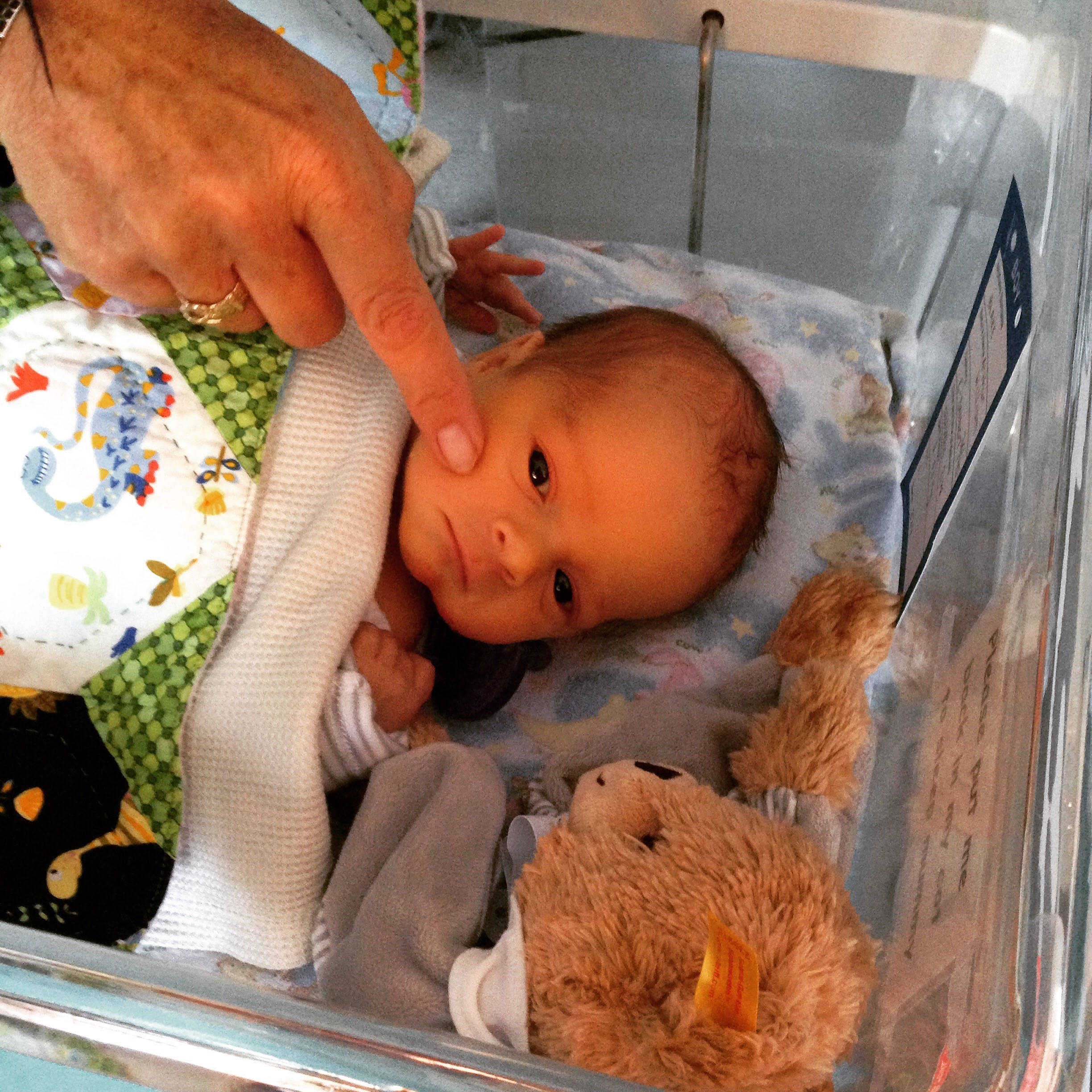 A photograph of baby Arthur Blake with a teddy