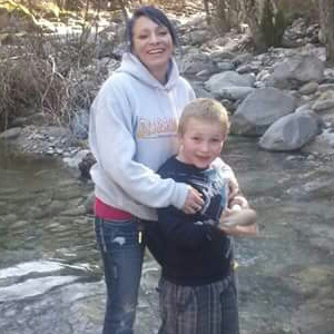 A photograph of Boyd Steel Rogers and another person standing by a river