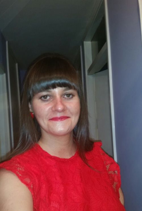 A photograph of Cara Smith in a corridor