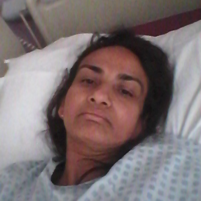 A photograph of Chandra in a hospital bed