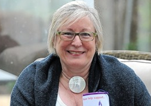 Photograph of Christine Carter holding a fundraising box.