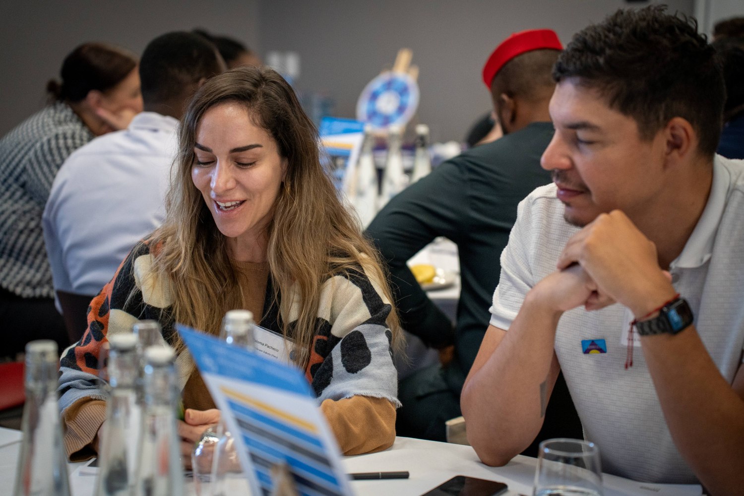 Two people at a table talking to eachother