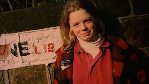 A photograph of Elizabeth Cavanagh next to a street sign