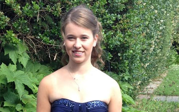 Portrait photo of Ambassador Ella Bailey smiling outdoors.