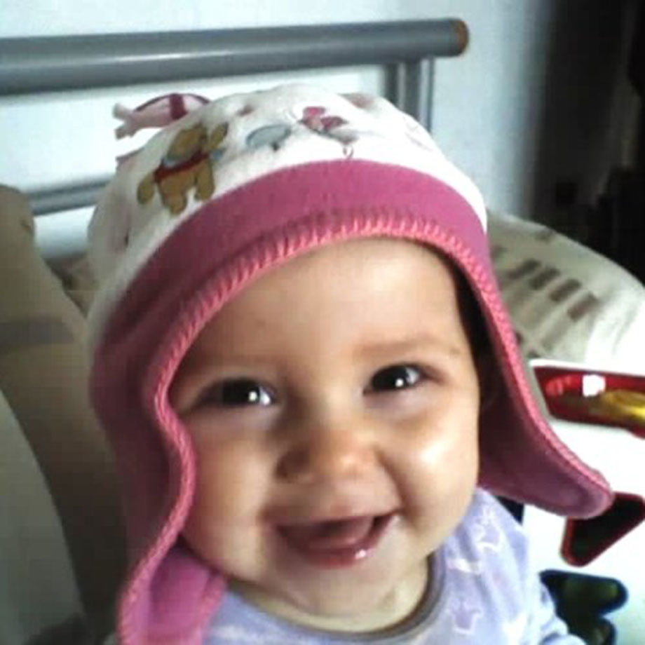 A photograph of baby Ellie Mae wearing a hat