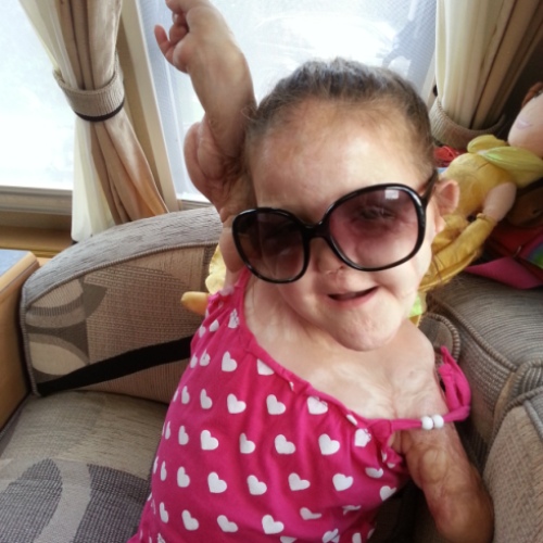 A photograph of Ellie Mae wearing sunglasses