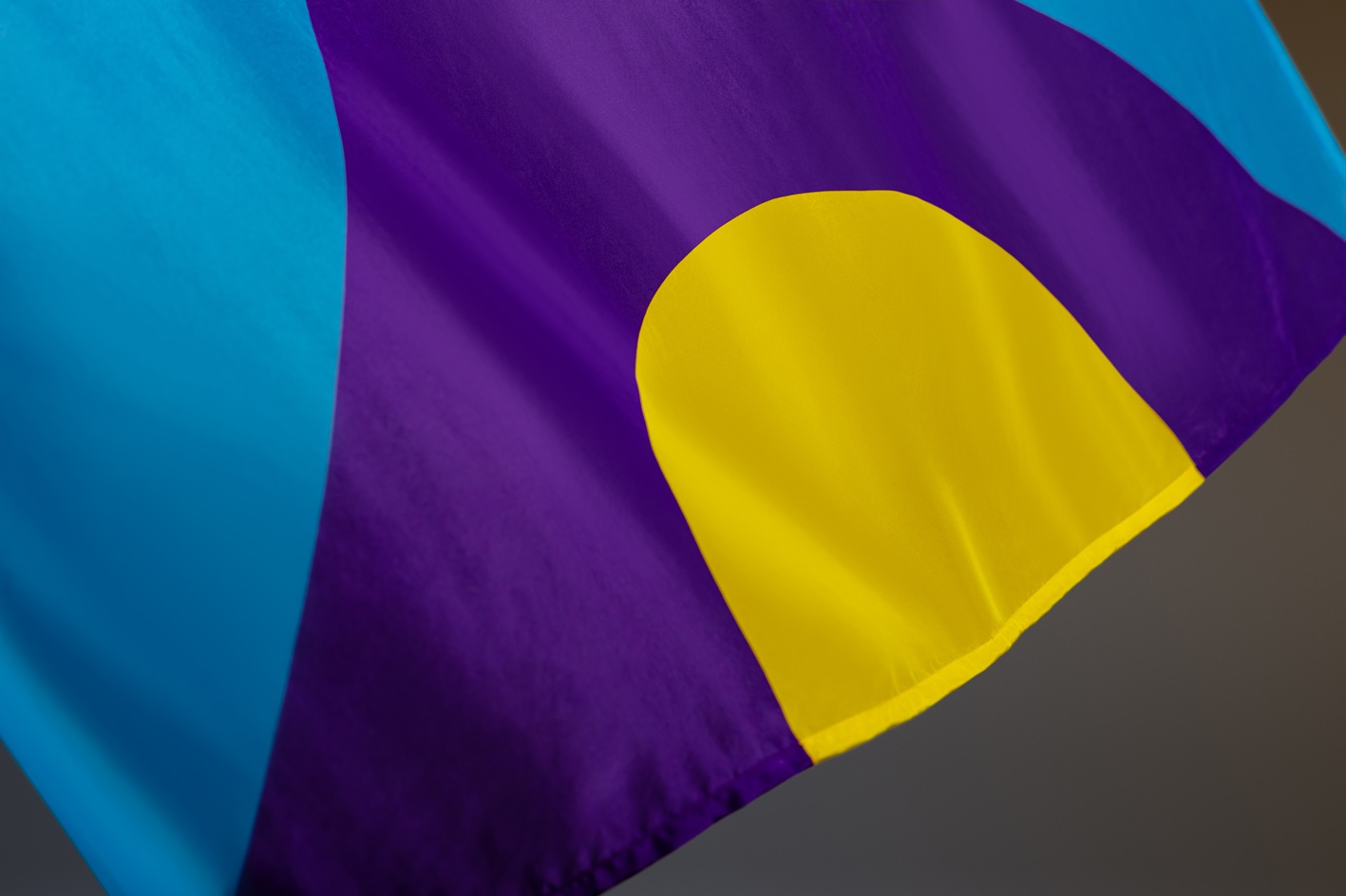 A section of the meningitis flag, showing a yellow, purple and blue geometric design.