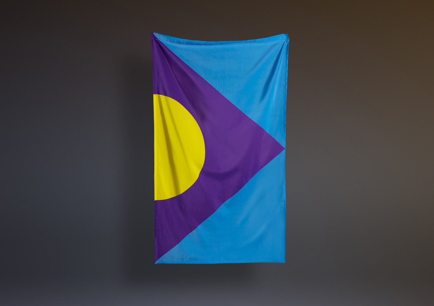 A flag design with a yellow semi-circle at the base, surrounded by a purple triangle, against a blue background.