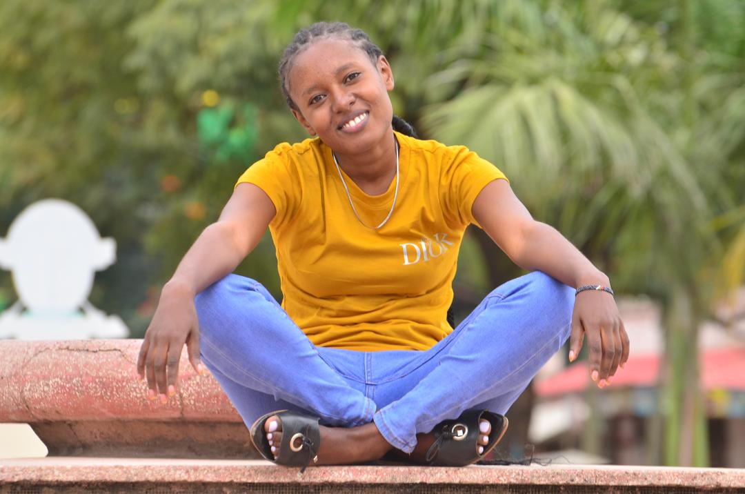 Isabell Wachera smiling with her legs crossed