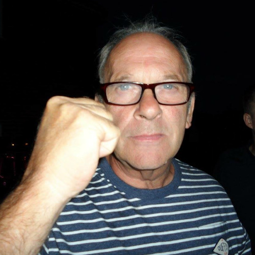 A photograph of Jack McCord making a fist at the camera
