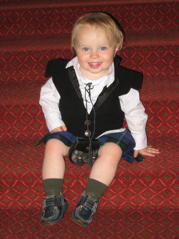 A photograph of Jacob Niblett sitting on a flight of stairs