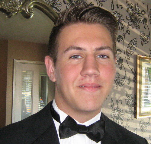 A photograph of Jake Hilton in a tuxedo