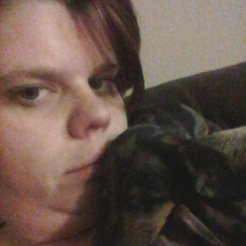 A close up photograph of Jule Shafer holding a dog