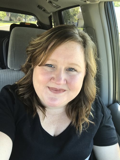 A photograph of Kristen Gillespie sitting in a car