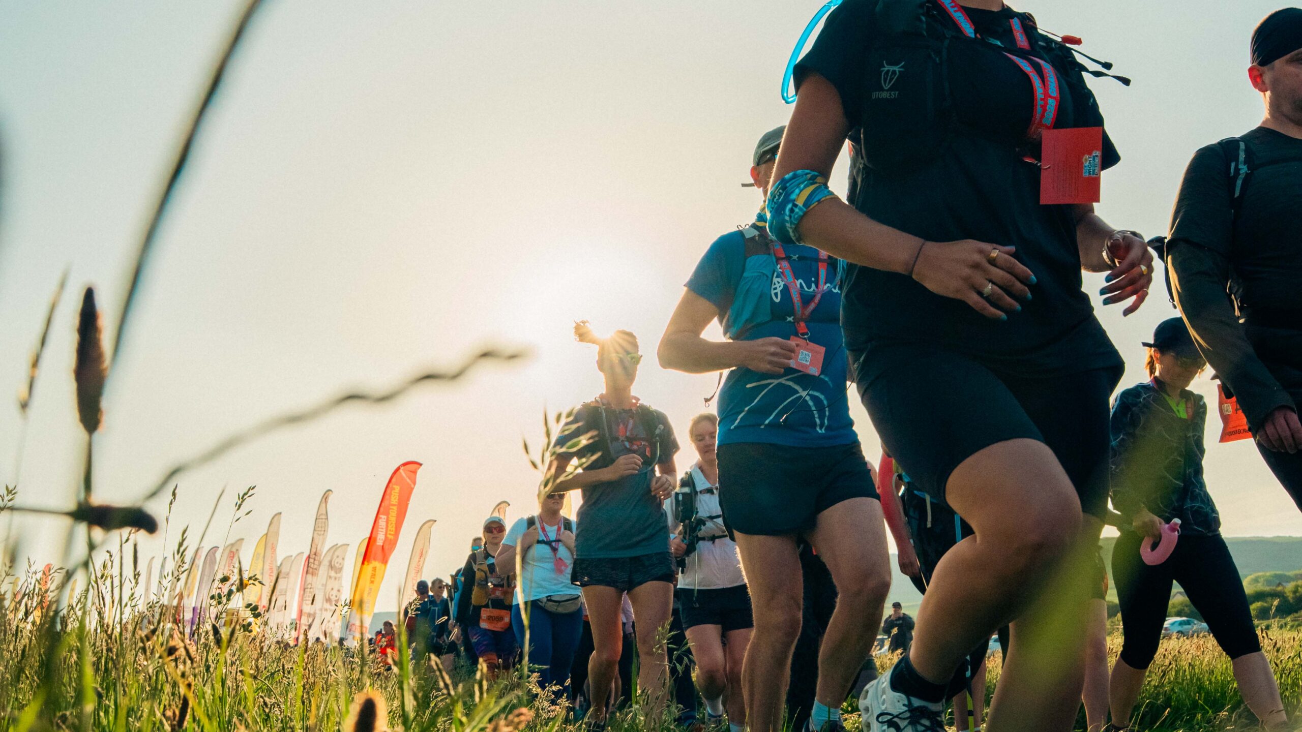 Participants making their way through a sunny field.
