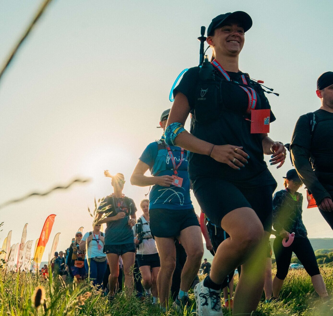 Participants making their way through a sunny field.