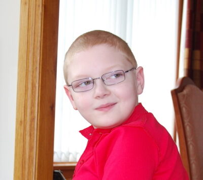 A photograph of Lee Thorburn wearing a red t-shirt