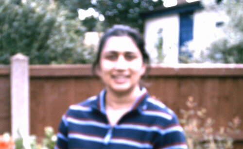 A photograph of Linda Budhu in a garden