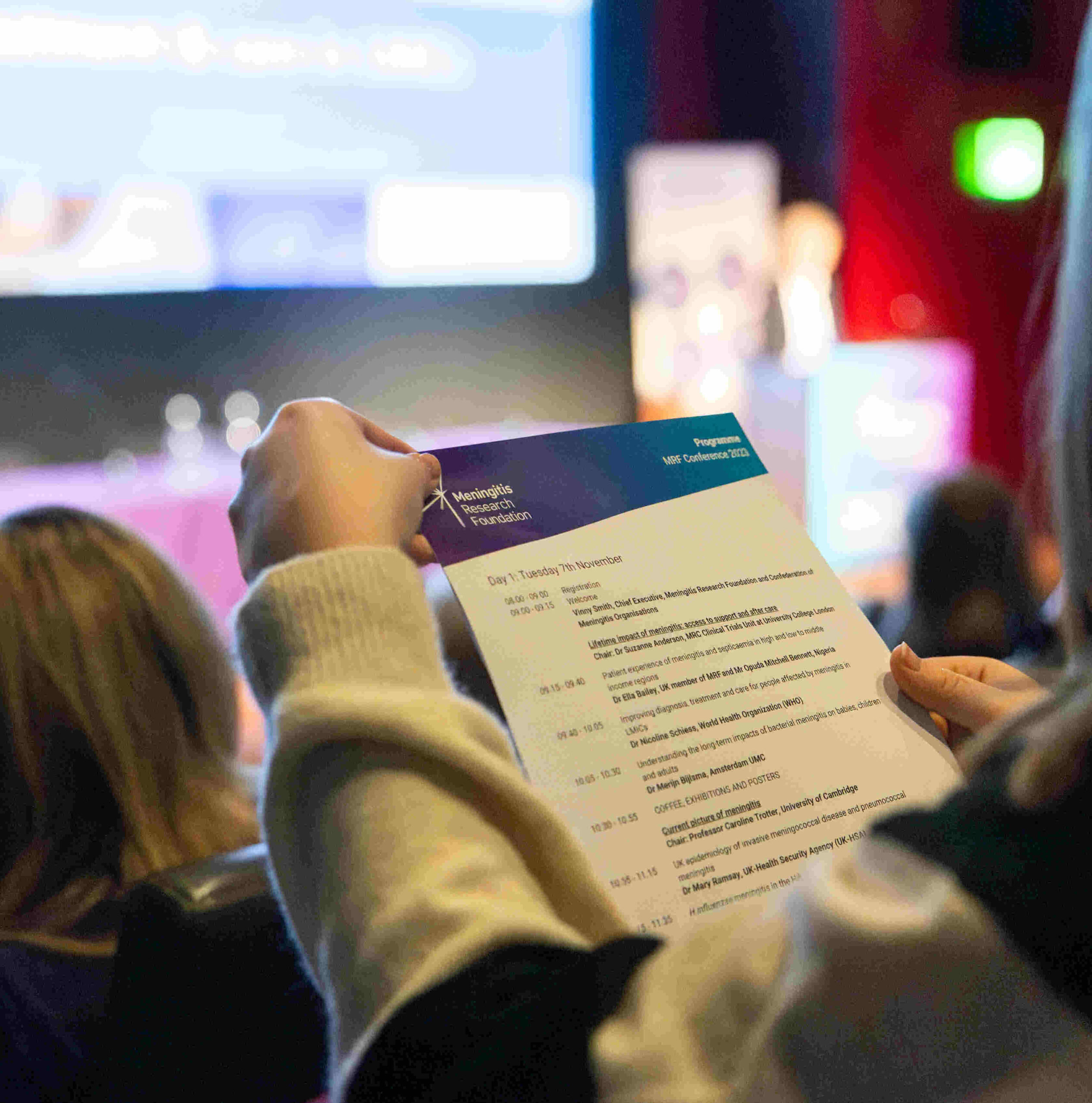 Person holding agenda for the MRF Conference