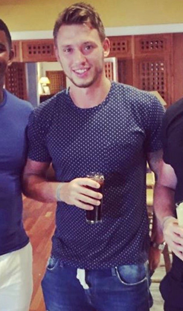 A photograph of Matt Collino holding a drink