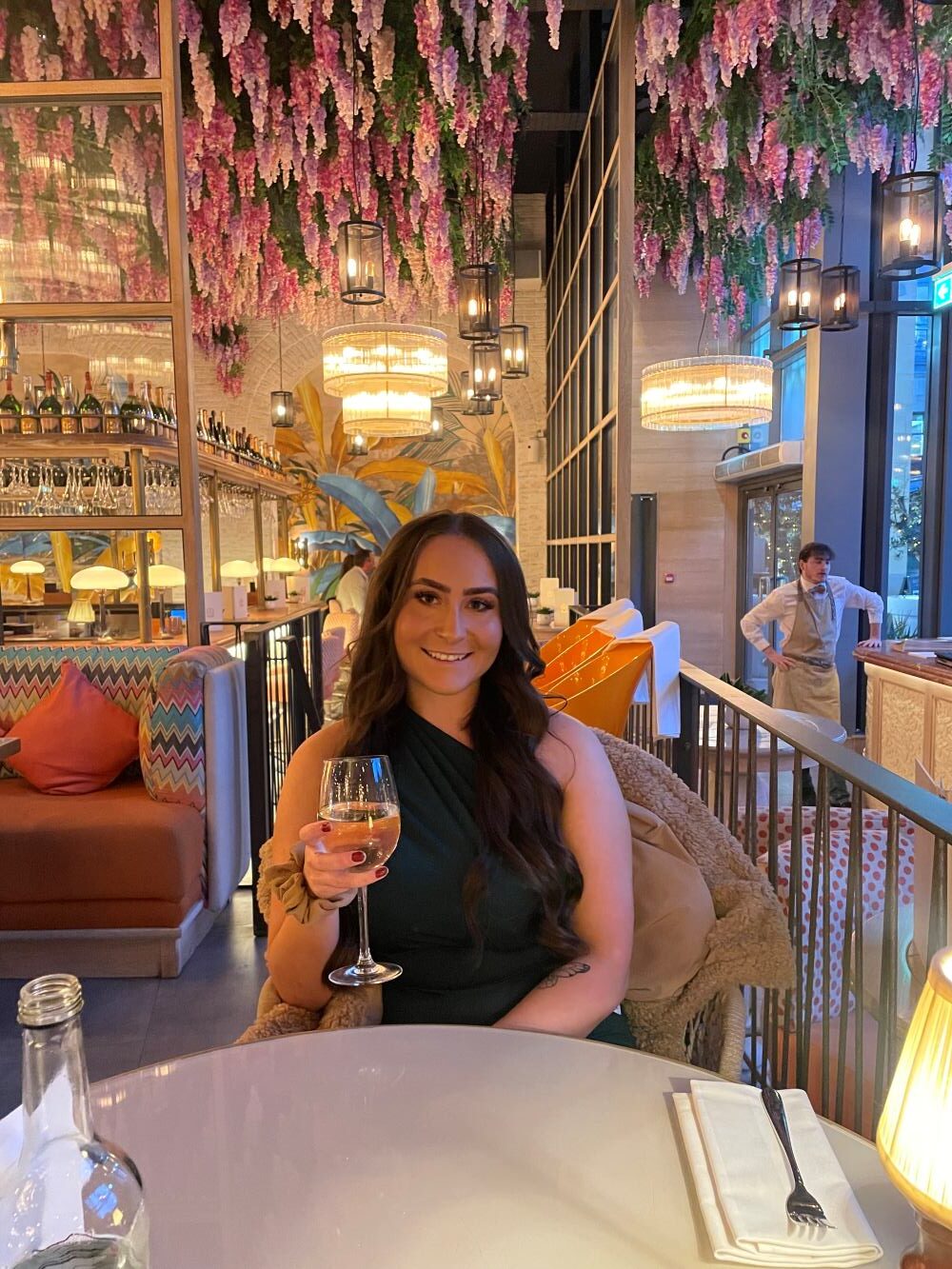 Mhairi Easton at a restaurant holding a glass of wine