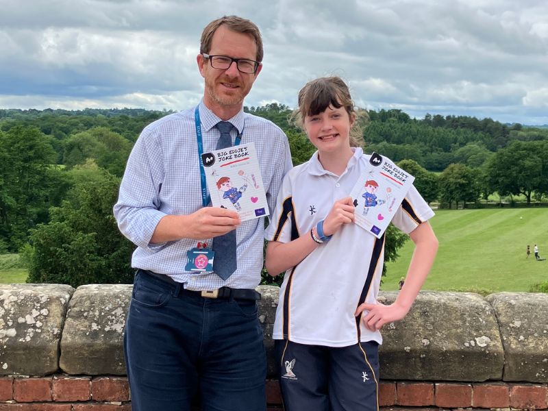 Ollie and Maddie Davies smiling holding Big Eddie's Joke Book
