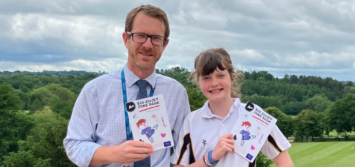 Ollie and Maddie Davies smiling holding Big Eddie's Joke Book