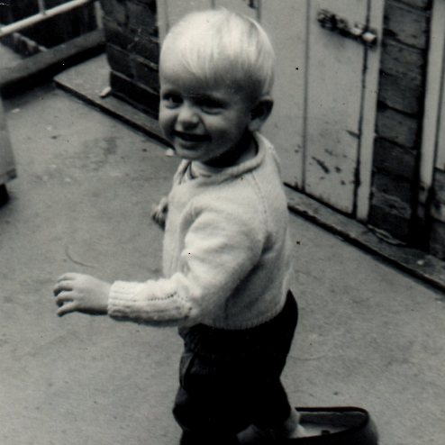 A black and white photograph of a toddler