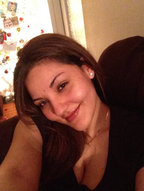 A photograph of Sara Mizra smiling at the camera