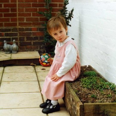 A photograph of Sophie Bell sitting on a plant pot
