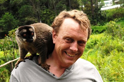 A photograph of Tim Beacon with a lemur on his shoulder