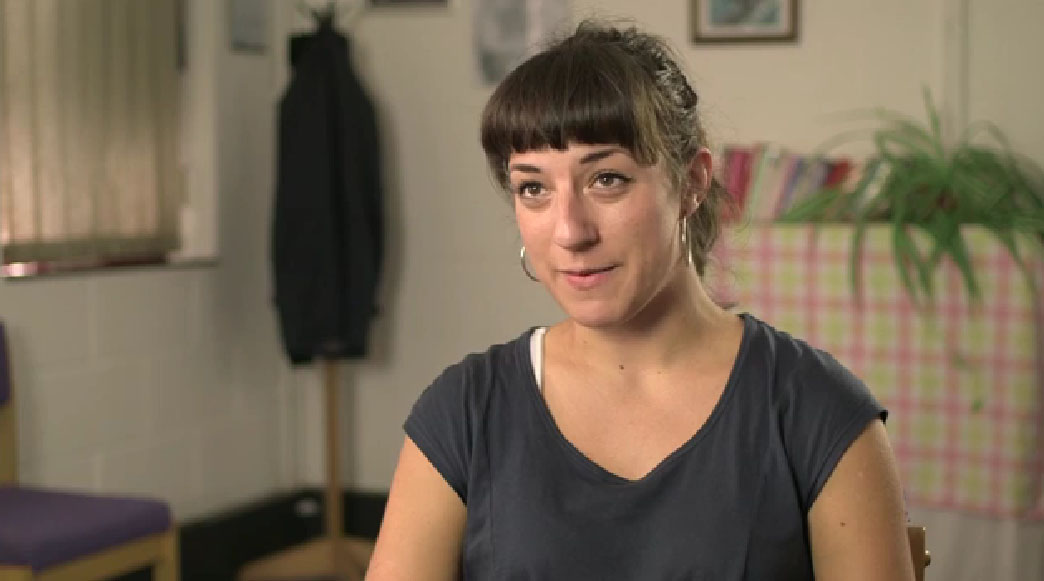 A screenshot of Kathleen Hawkins talking in the video