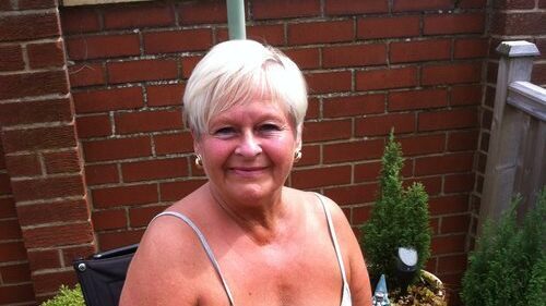 A photograph of Viv Bell sitting in her wheelchair