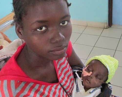 A photograph of Faith Banda holding baby Roselyn