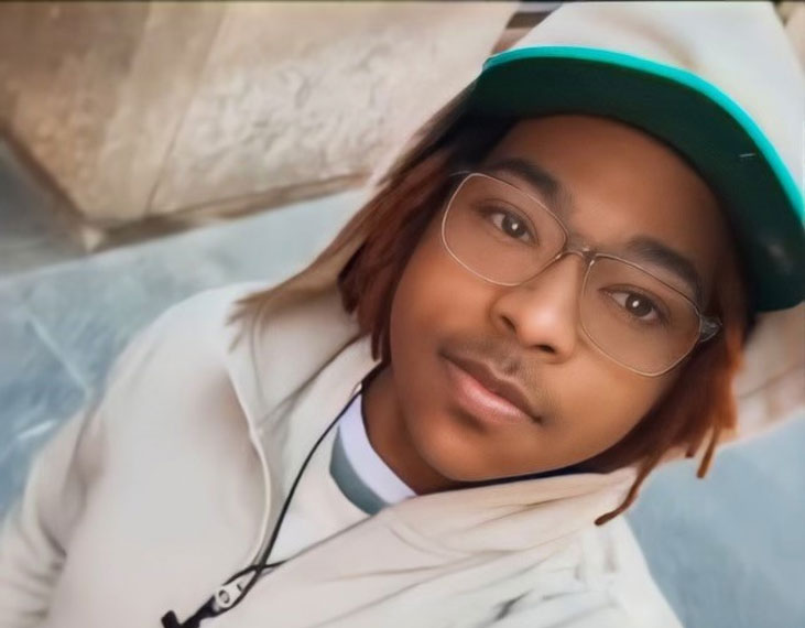 Spencer King wearing glasses and a cap