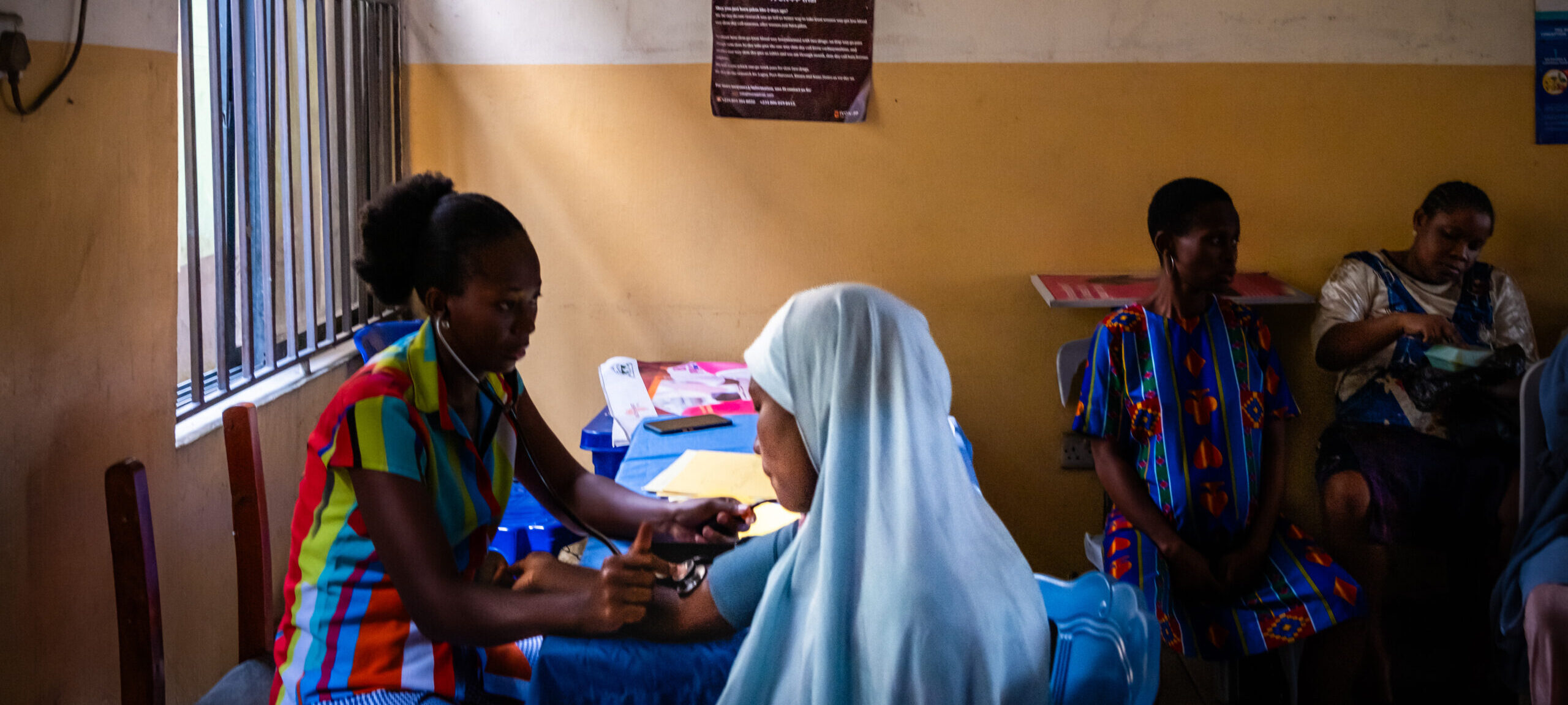 14 March 2024: Mothers receiving medical care and routine caregiver support at the Model Primary Health Care Provider in Mgbundukwu, Port Harcourt, Rivers State, Nigeria. Photograph by Daylin Paul for Meningitis Research Foundation