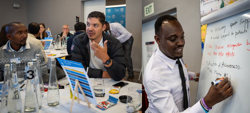 CoMO members in discussion with one writing on a whiteboard