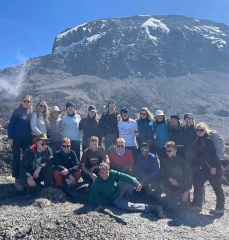 Students huddled round a big mountain.