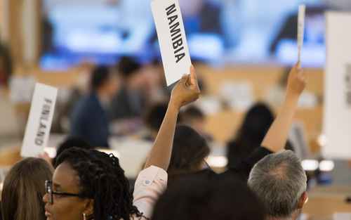 People holding placards with country names on